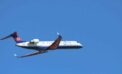 white and red air plane in flight Bombardier the poster child of pork-barrel cronyism